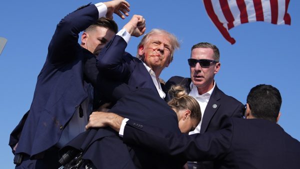 Trump is injured but ‘fine’ after apparent assassination attempt leaves rally-goer and gunman dead